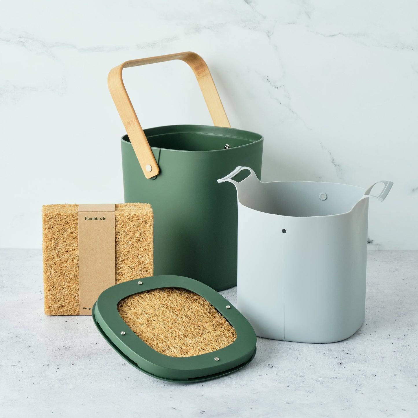 Astrik Compost Starter Bundle in Forest color on a light gray surface.