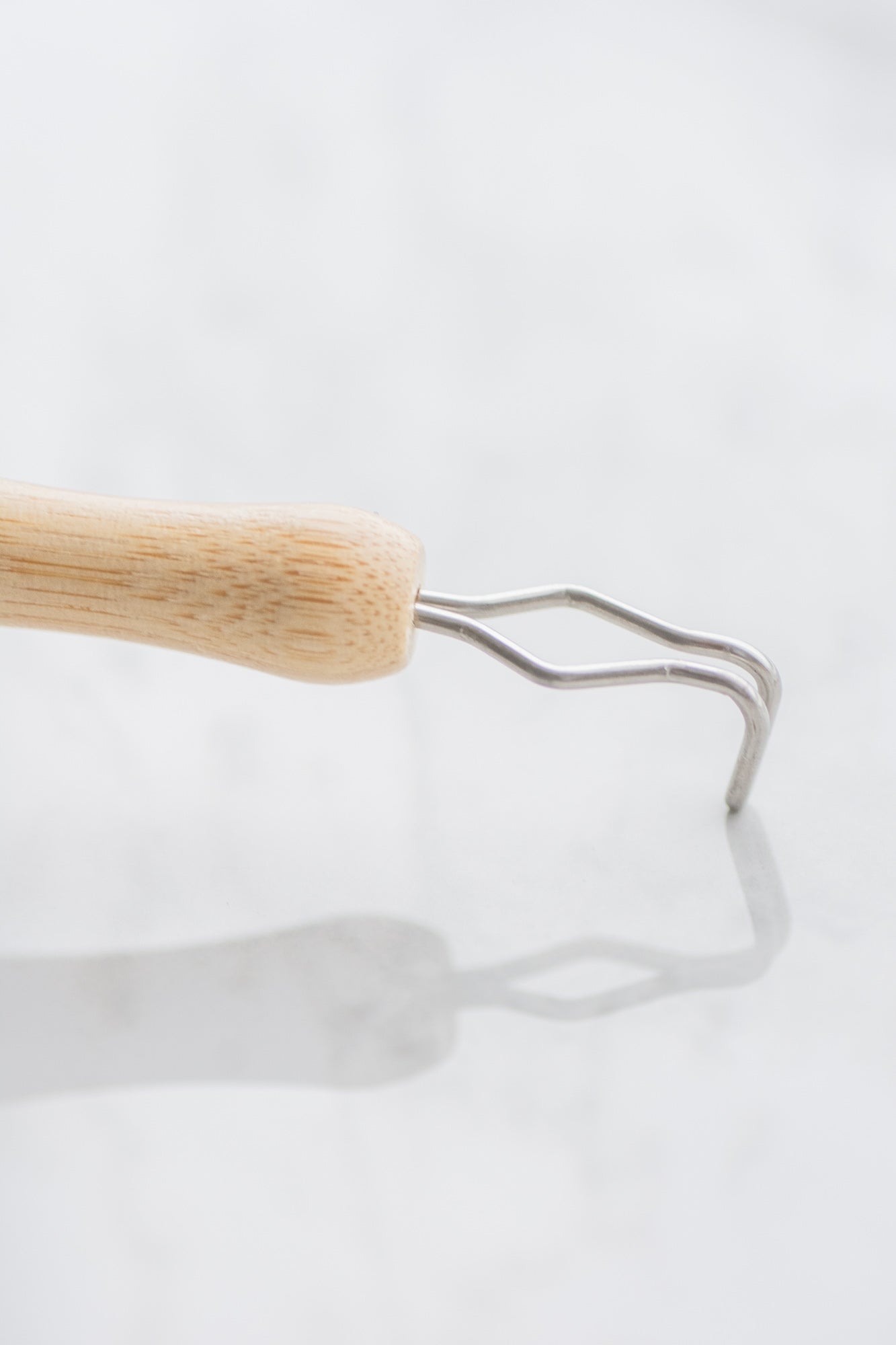 Bamboo dishwashing scrubber brush with detachable head - vegan, compostable and plastic free - on a white background