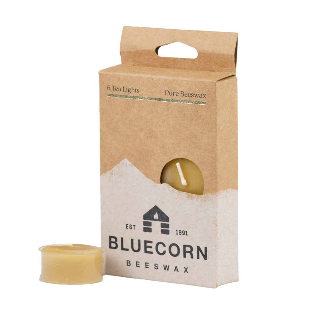 Bluecorn Beeswax tea light packaging with a single tea light in front on a white background