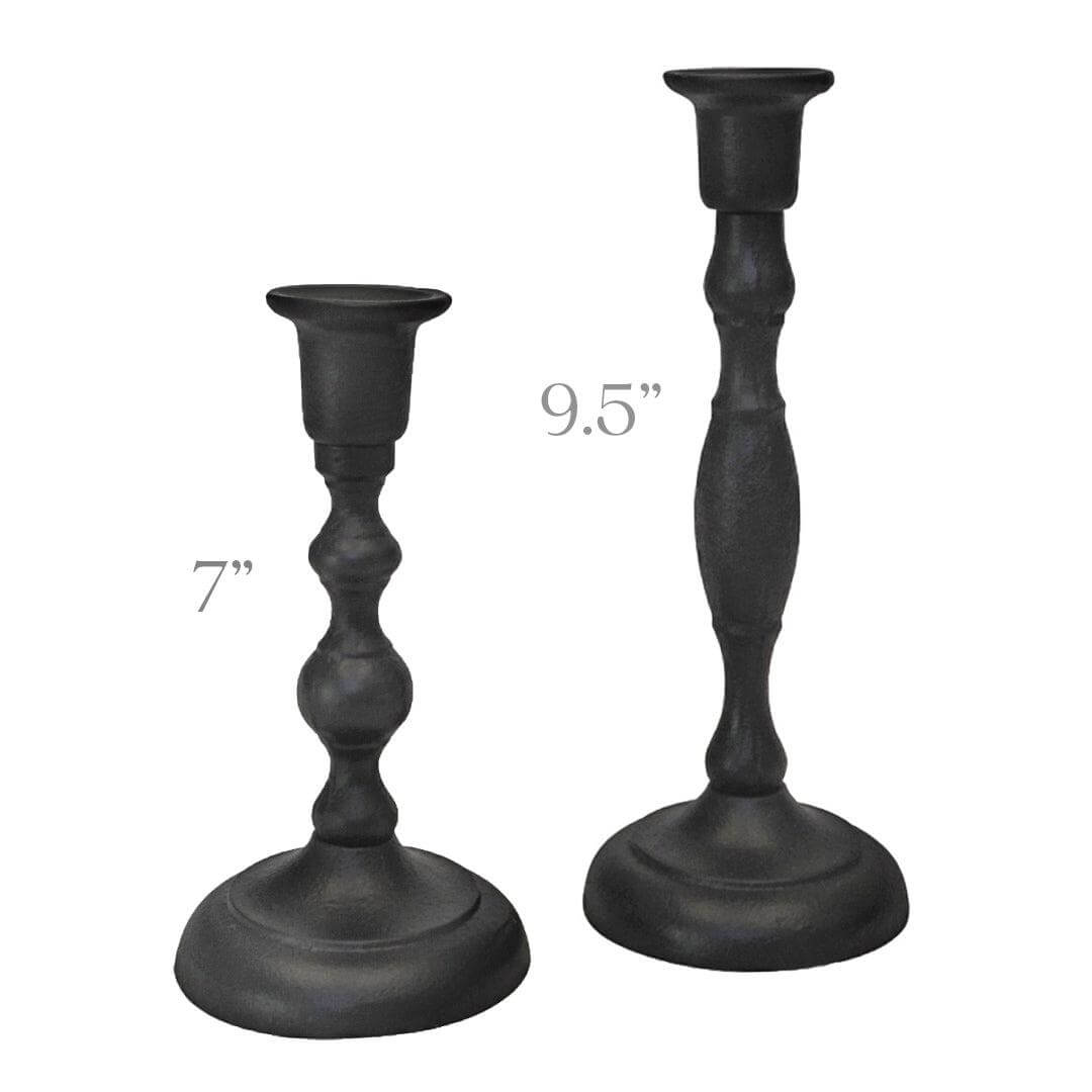 Two black candlesticks with measurements on a white background