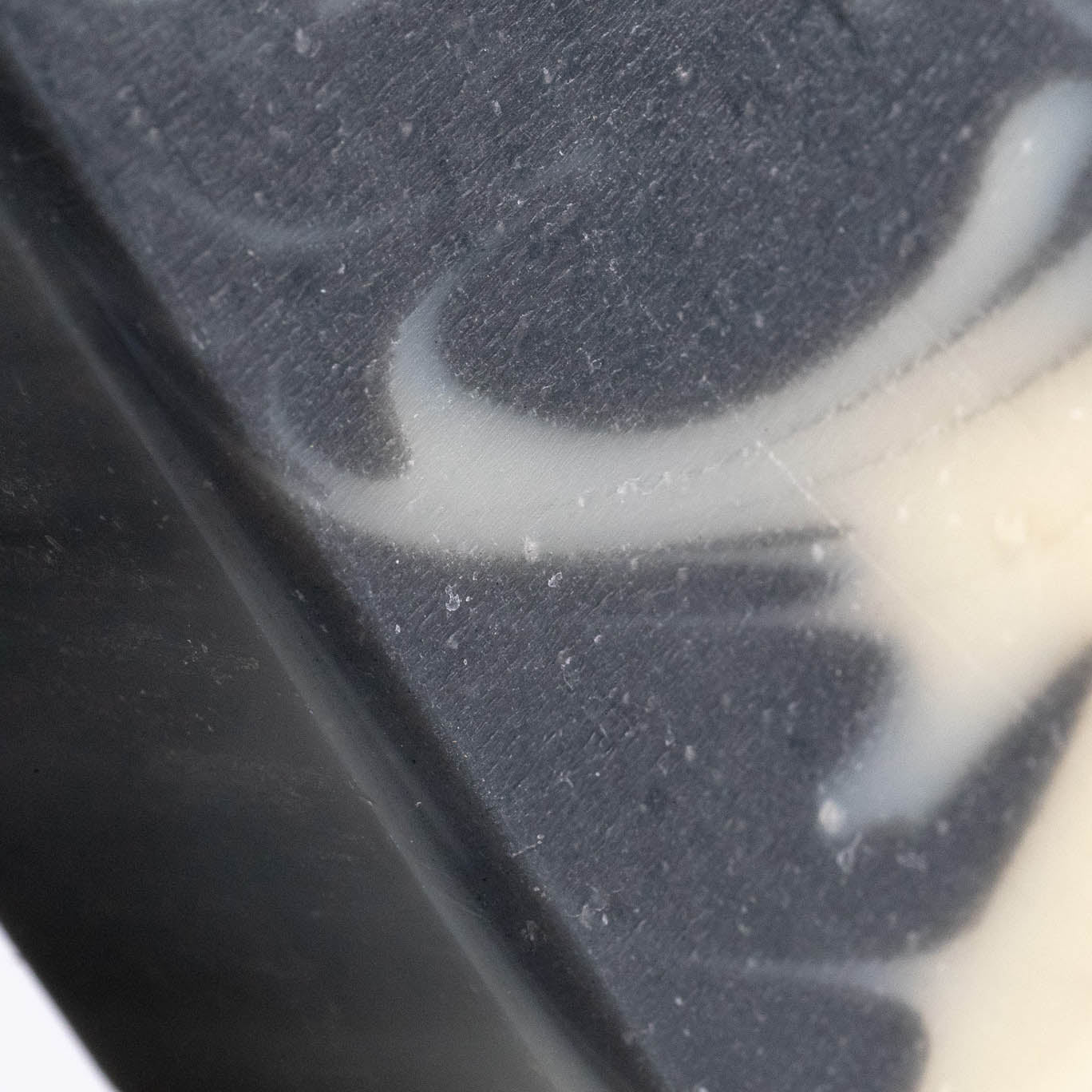 Close-up of a detoxifying charcoal soap bar