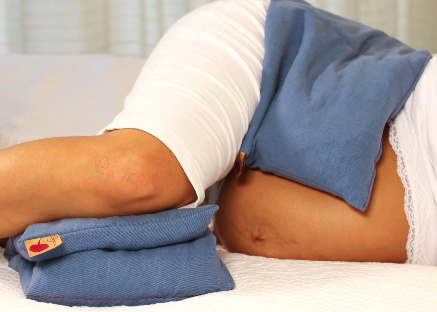 Double Square Blue Natural Dyed Denim Hot and Cold Pillow being used by a pregnant woman.
