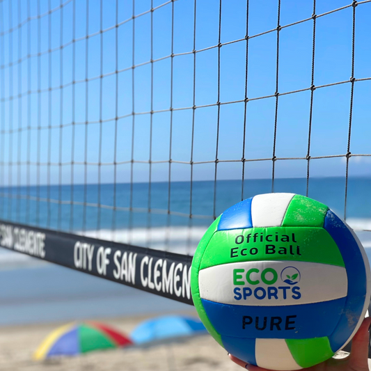 Eco Sports Vegan Beach Volleyball in front of a volleyball net on a beach.