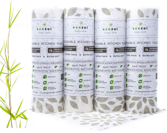 Four rolls of ecozoi reusable bamboo paper towels kitchen towels on a white background with greenery.