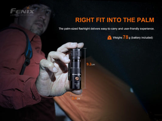 Person holding a palm-sized Fenix PD25R Rechargeable LED Flashlight with product details on a dark background