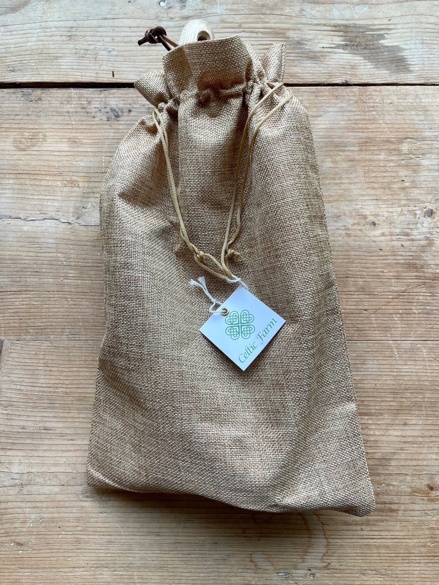 Burlap drawstring bag with a the 5-piece garden master tool set, displayed on a wooden surface