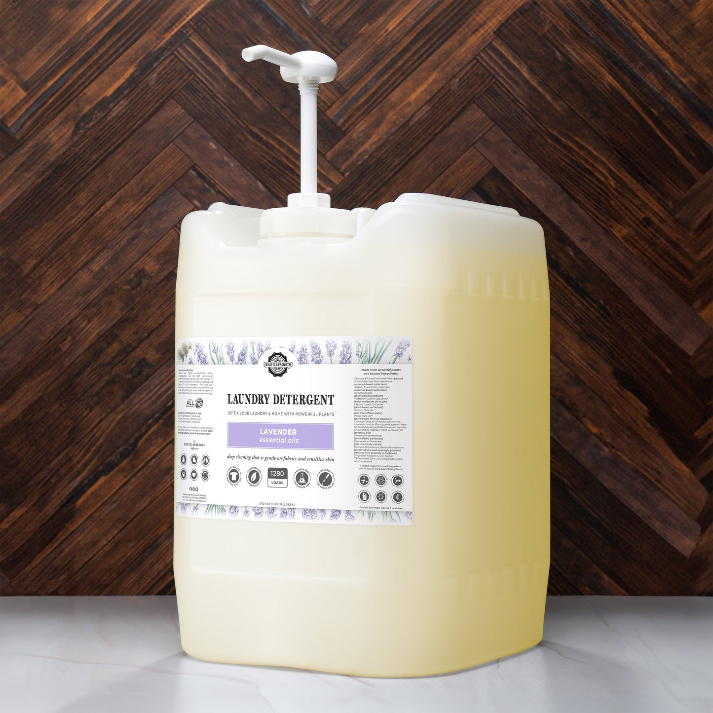 5 gallon container of laundry detergent with a pump against a wooden background
