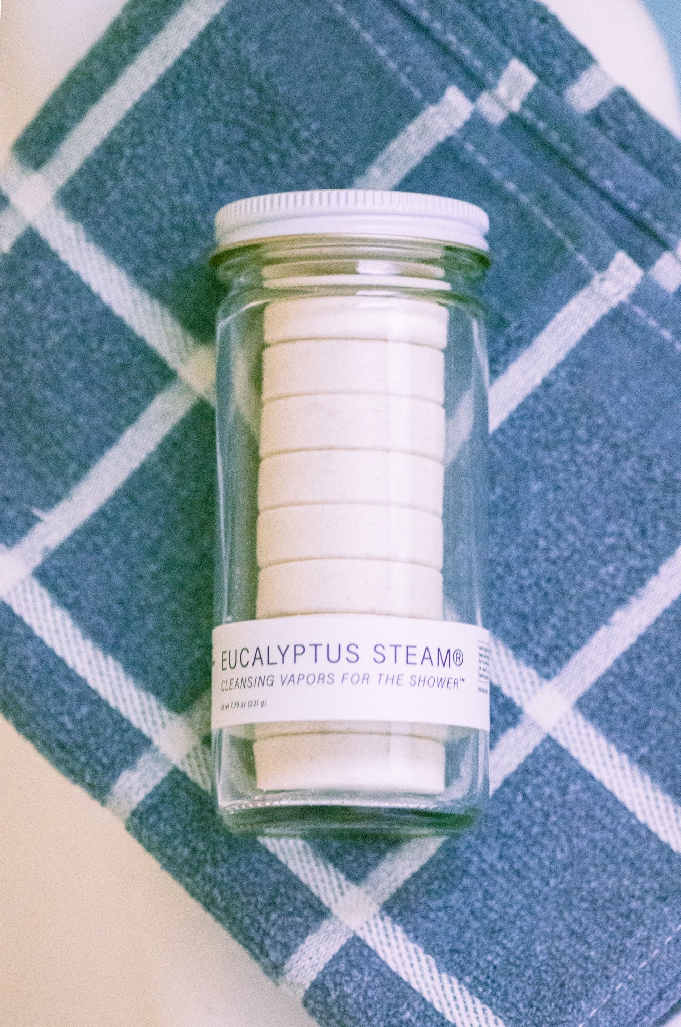 Jar of eucalyptus steam cleansing vapers on a blue checkered towel