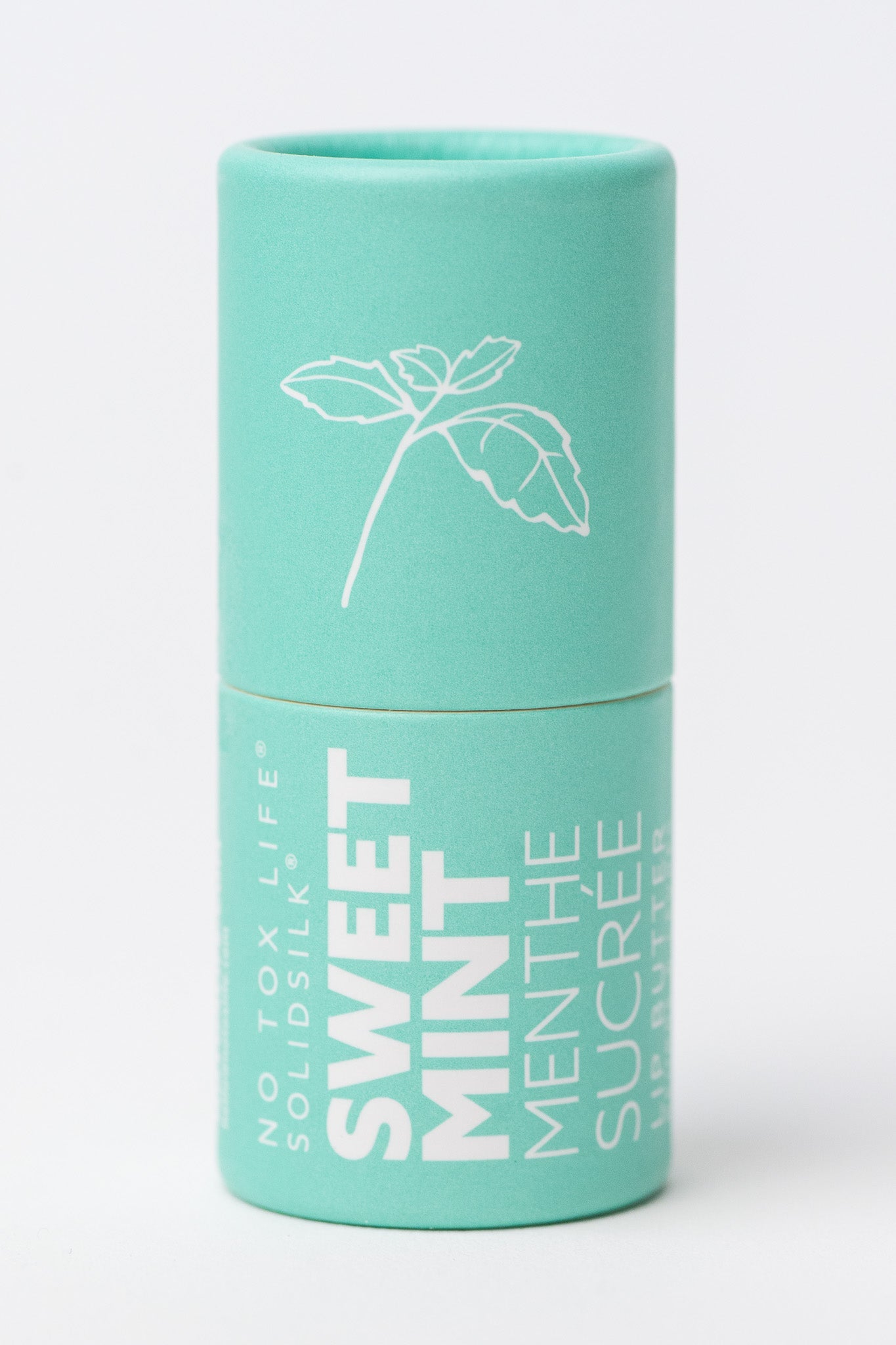 Mint green cylindrical container with No Tox Life Sweet Mint Lip Butter and a plant illustration on a white background.