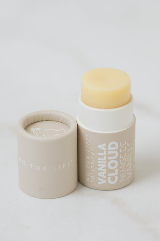 Vanilla cloud lip butter in beige paper tube on a white background