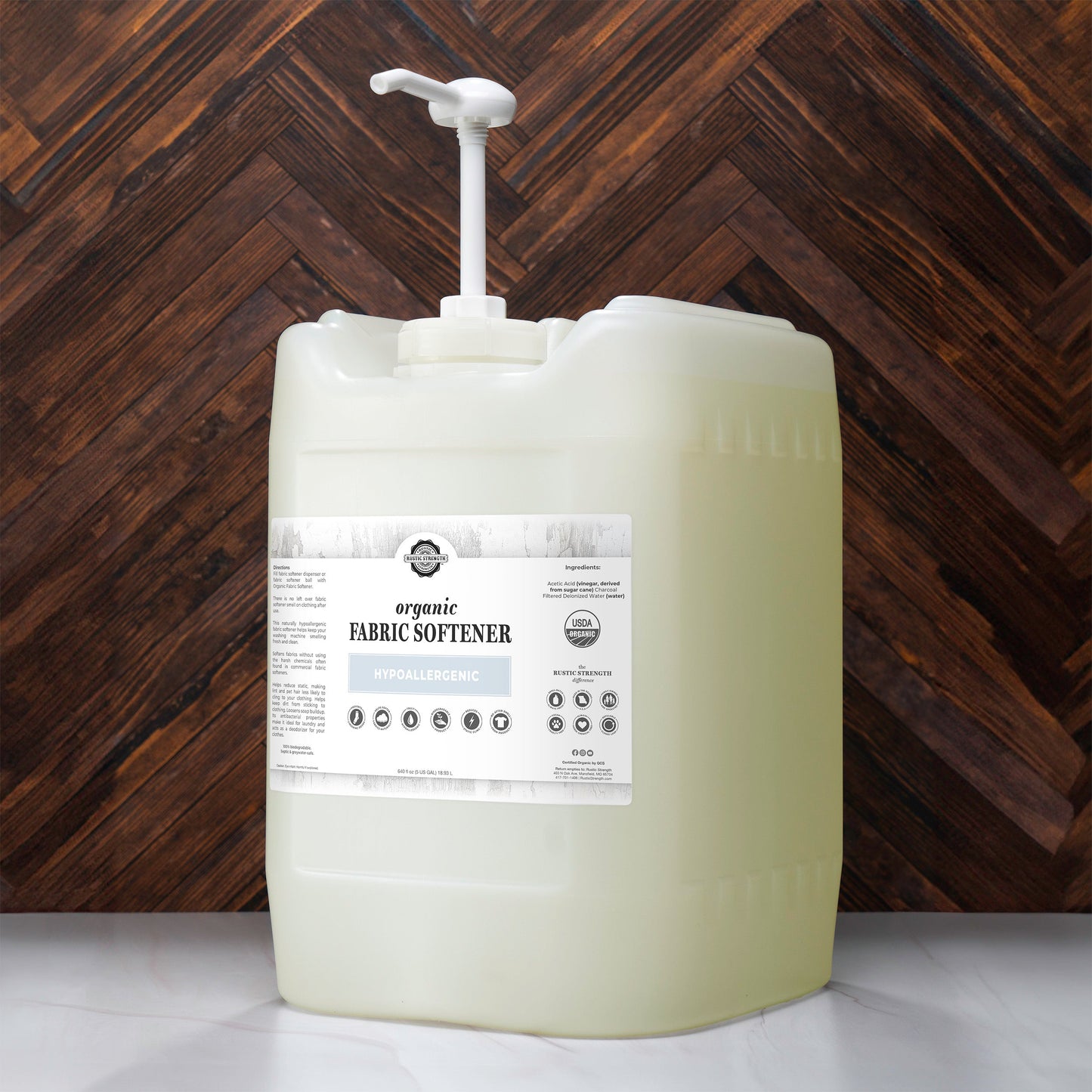 5 gallon container of fabric softener with a label on a wooden background