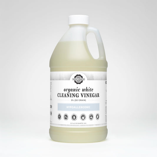 Bottle of organic white cleaning vinegar on a white background