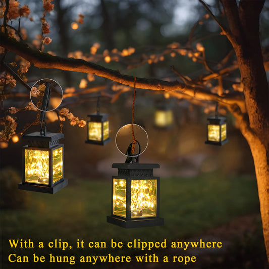 Decorative lanterns hanging from tree branches with glowing lights, set against a natural outdoor background.