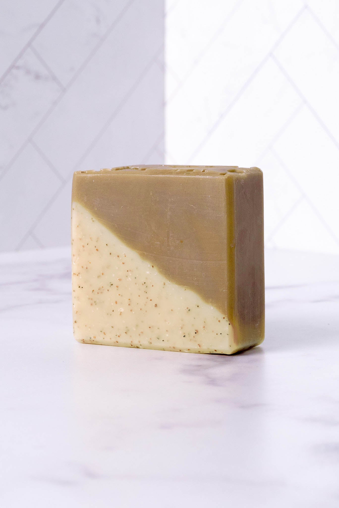 Two-tone sandalwood patchouli soap bar on a white background