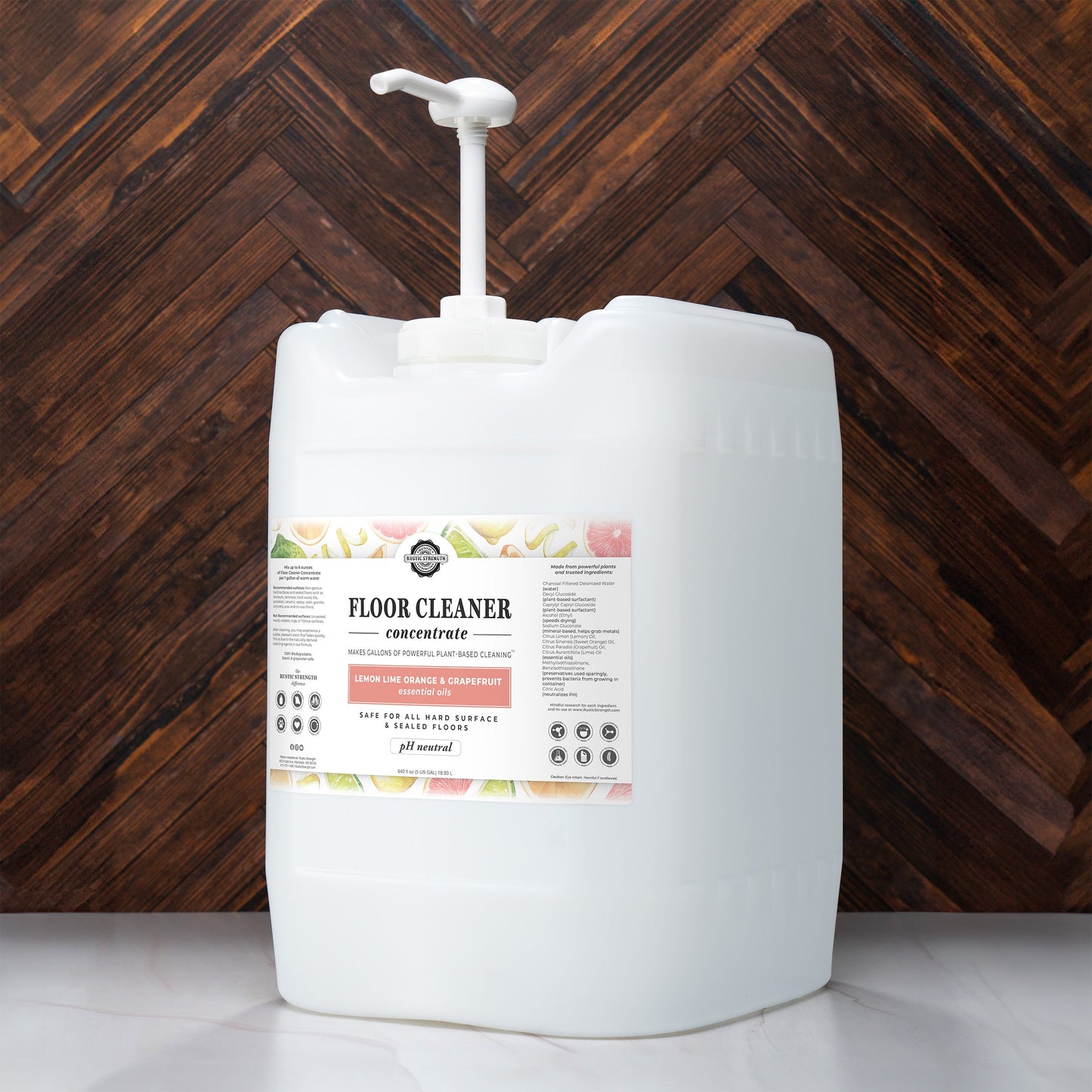 5-gallon container of Rustic Strength Floor Cleaner Concentrate with label against a wooden background