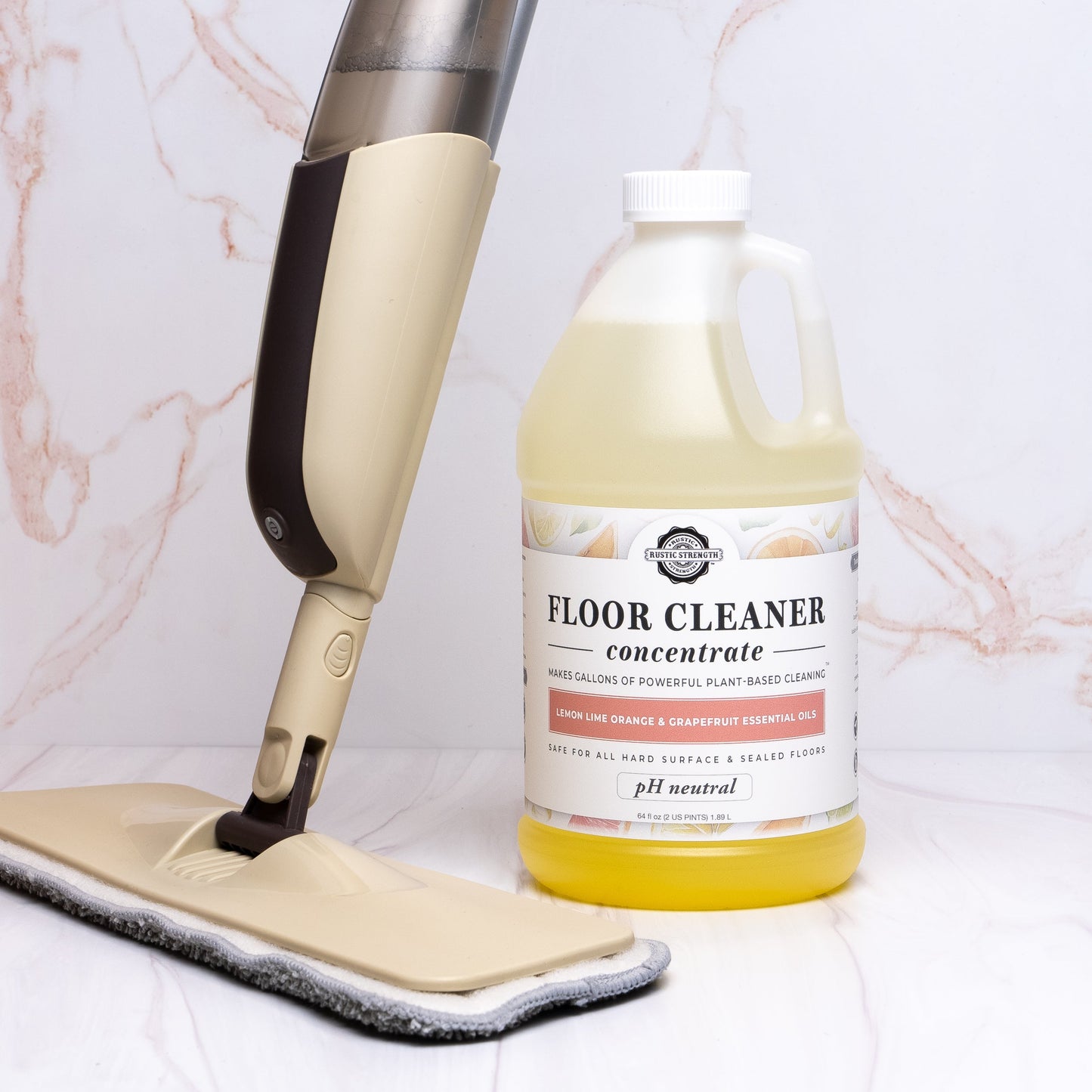 Rustic Strength floor mop and a bottle of floor cleaner on a marble surface