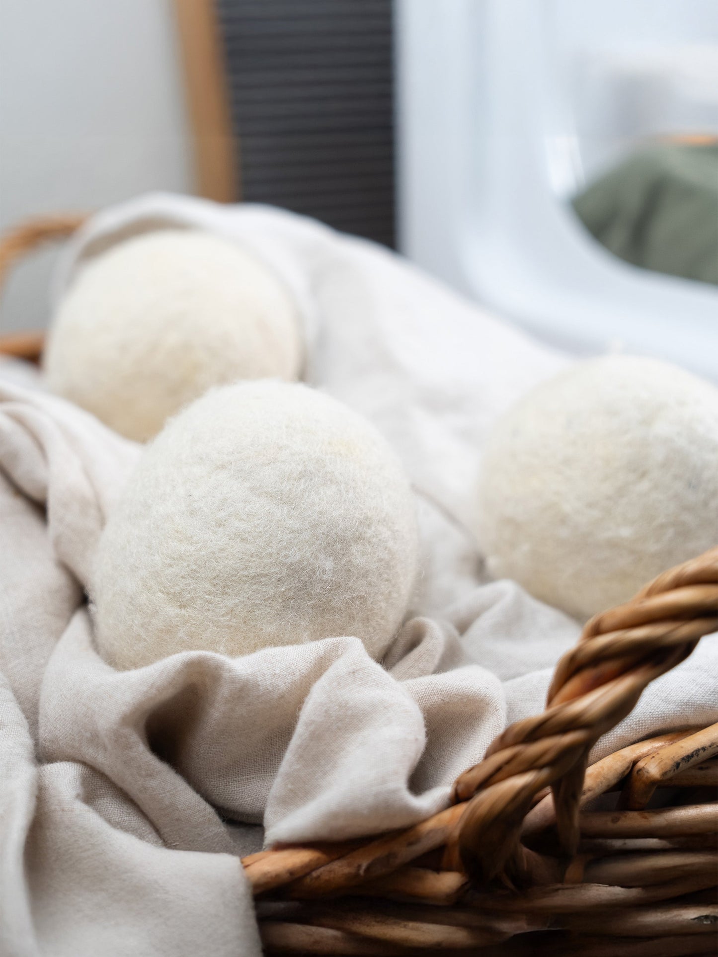 White laundry detergent balls in a wicker basket with fabric