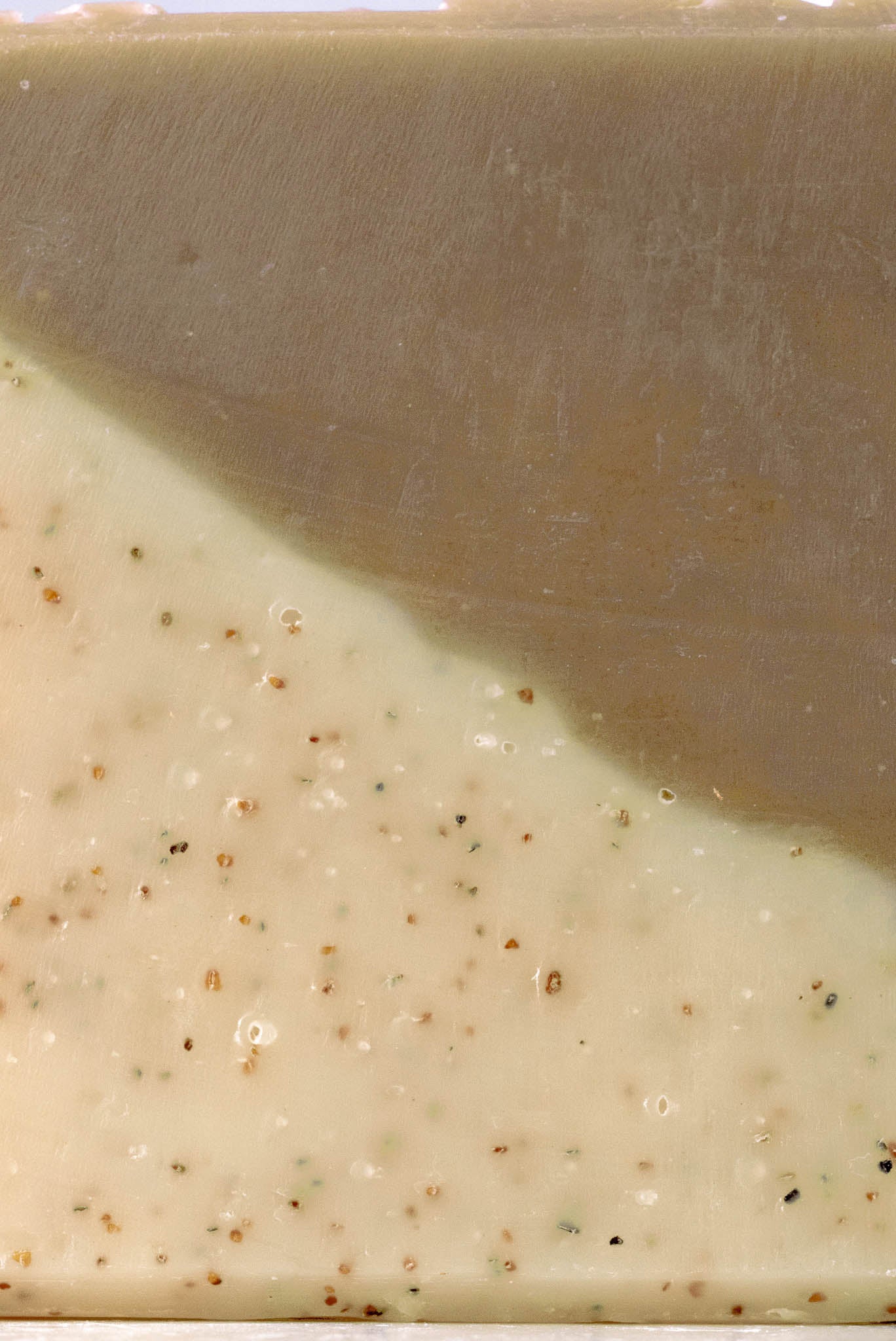 Close-up of a bar of sandalwood patchouli soap with a visible gradient from brown to beige.