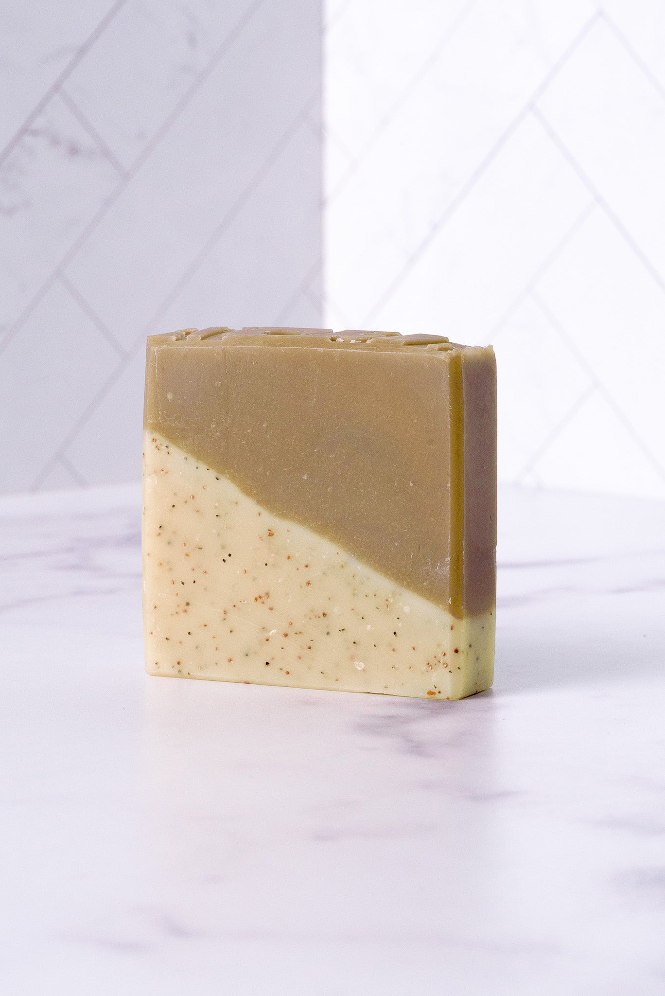 Two-tone sandalwood patchouli soap bar on a white background