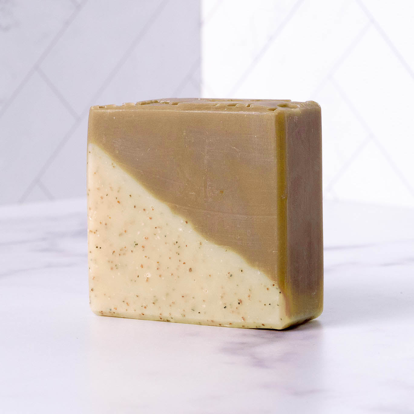 Two-tone sandalwood patchouli soap bar on a white background