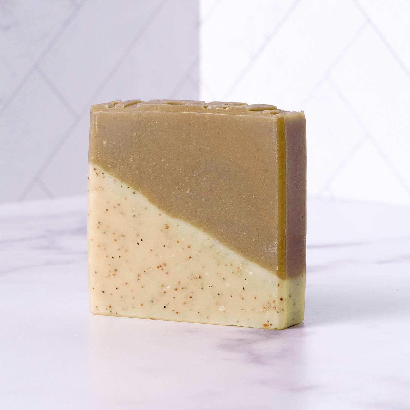 Two-tone sandalwood patchouli soap bar on a white background