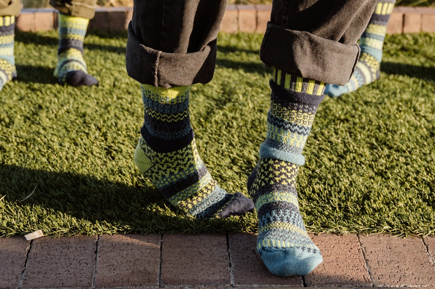 Solmate Lemongrass Crew socks worn on grass and pavement