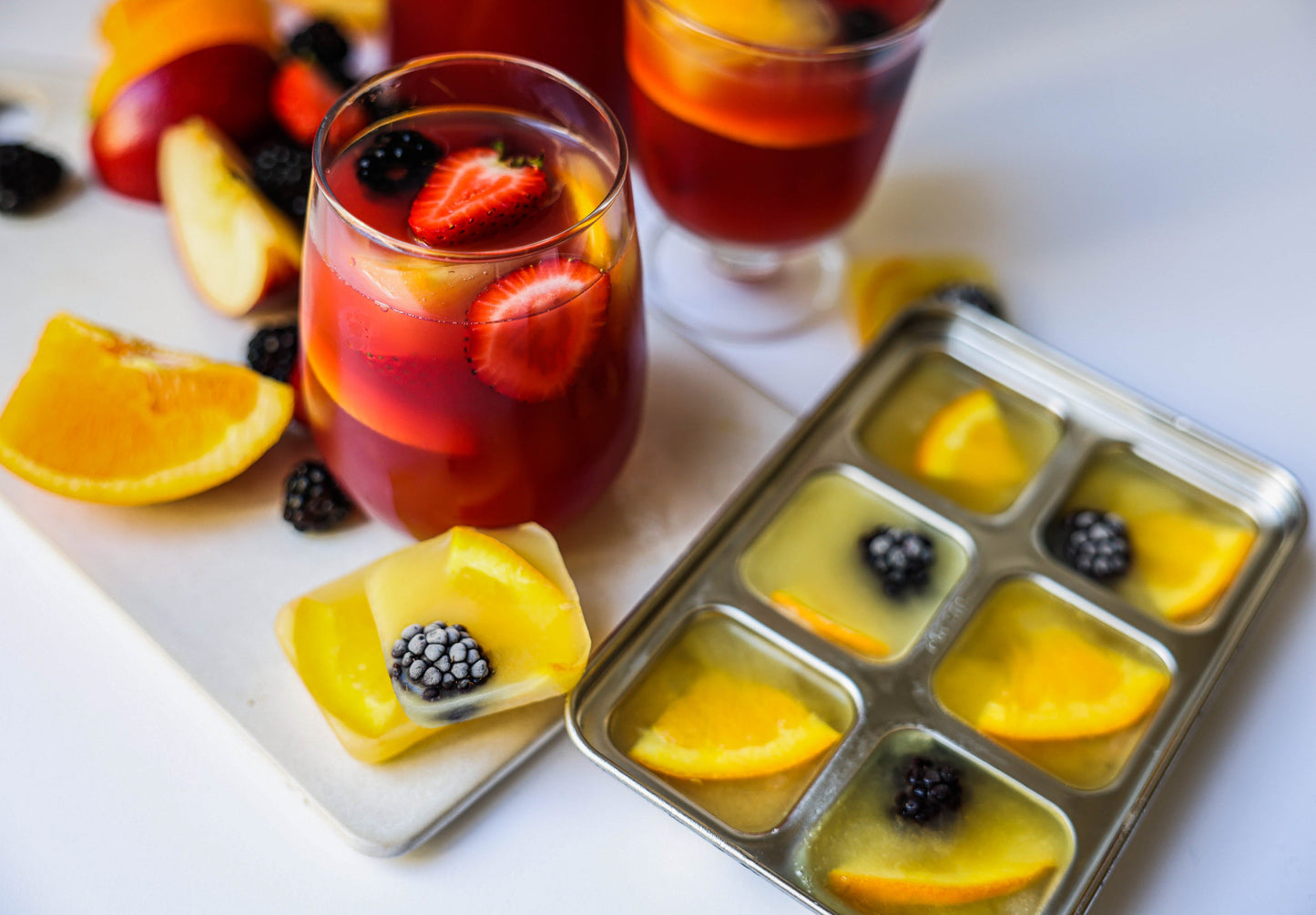 Fruity cocktails with fruit-filled ice cubes in a sustainable stainless steel ice cube tray