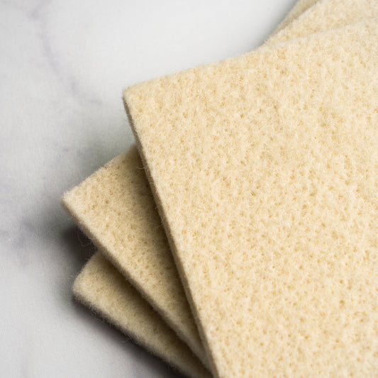Closeup of beige sponges on a light gray background