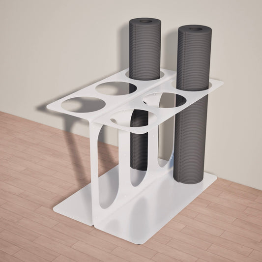 White Yoke yoga mat stand holding two of six yoga mats on a wooden floor.