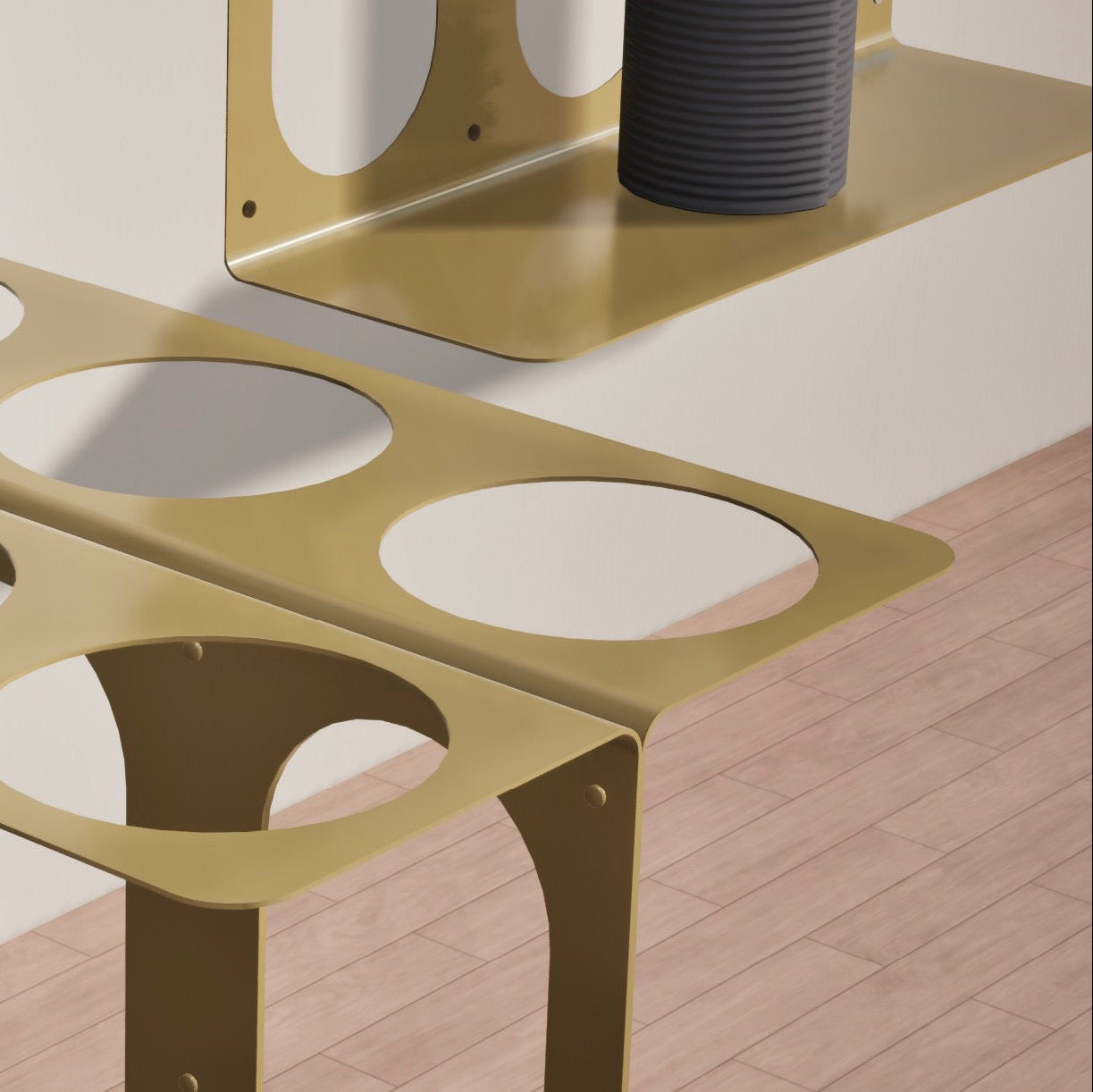 Closeup of yellow Yoke yoga mat stand with circular cutouts for mats on a wooden floor.