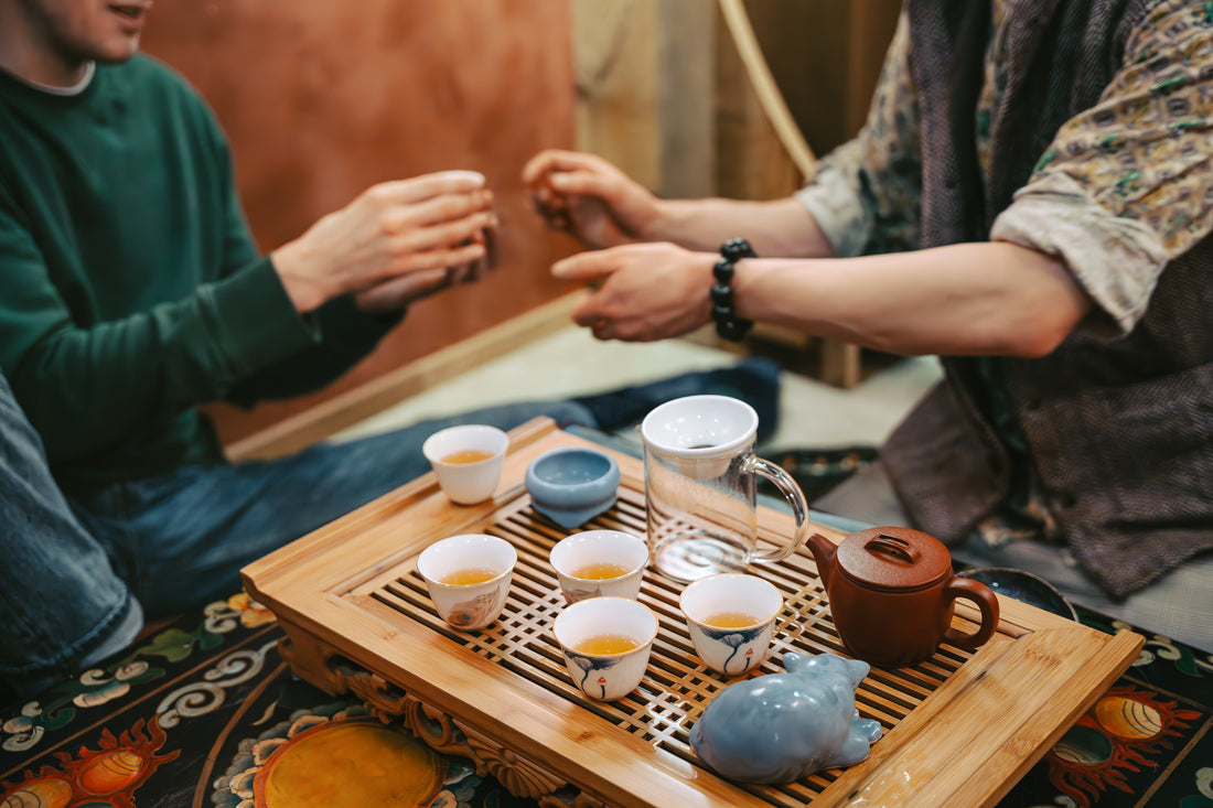 Earthinary Blog: Prime Day Is Not a Deal — It’s a Distraction. Here’s Why We’re Sitting It Out. People around a tea tray, socializing and enjoying a tea ceremony