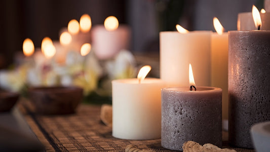 Natural wax candles in reusable glass vessels creating a warm, inviting atmosphere at home