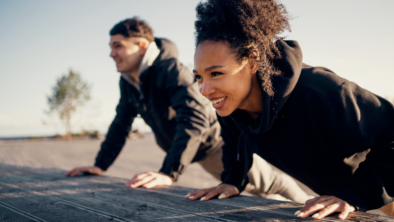 Woman and man stretching before cardio workout