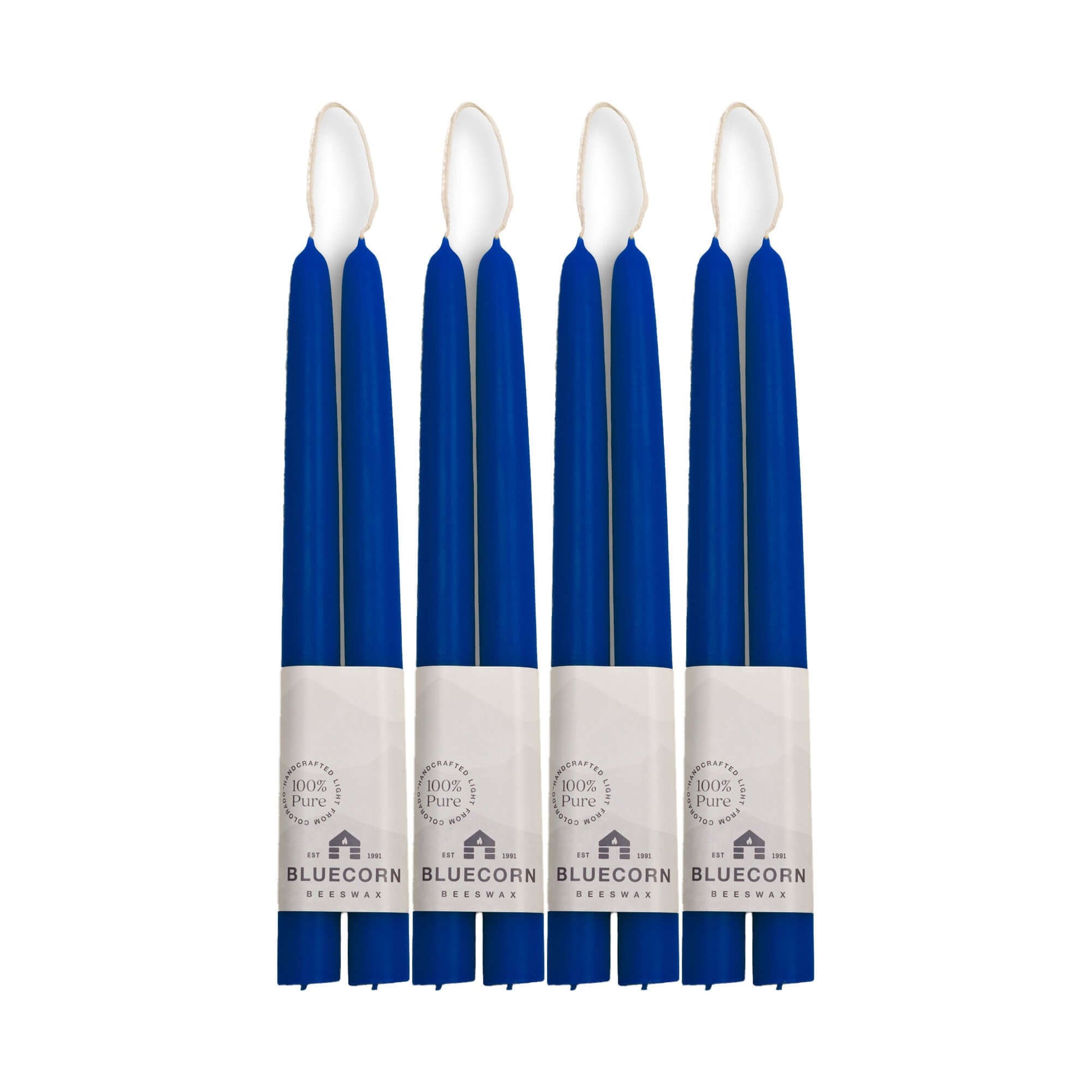 Set of eight blue candles with white wicks on a white background