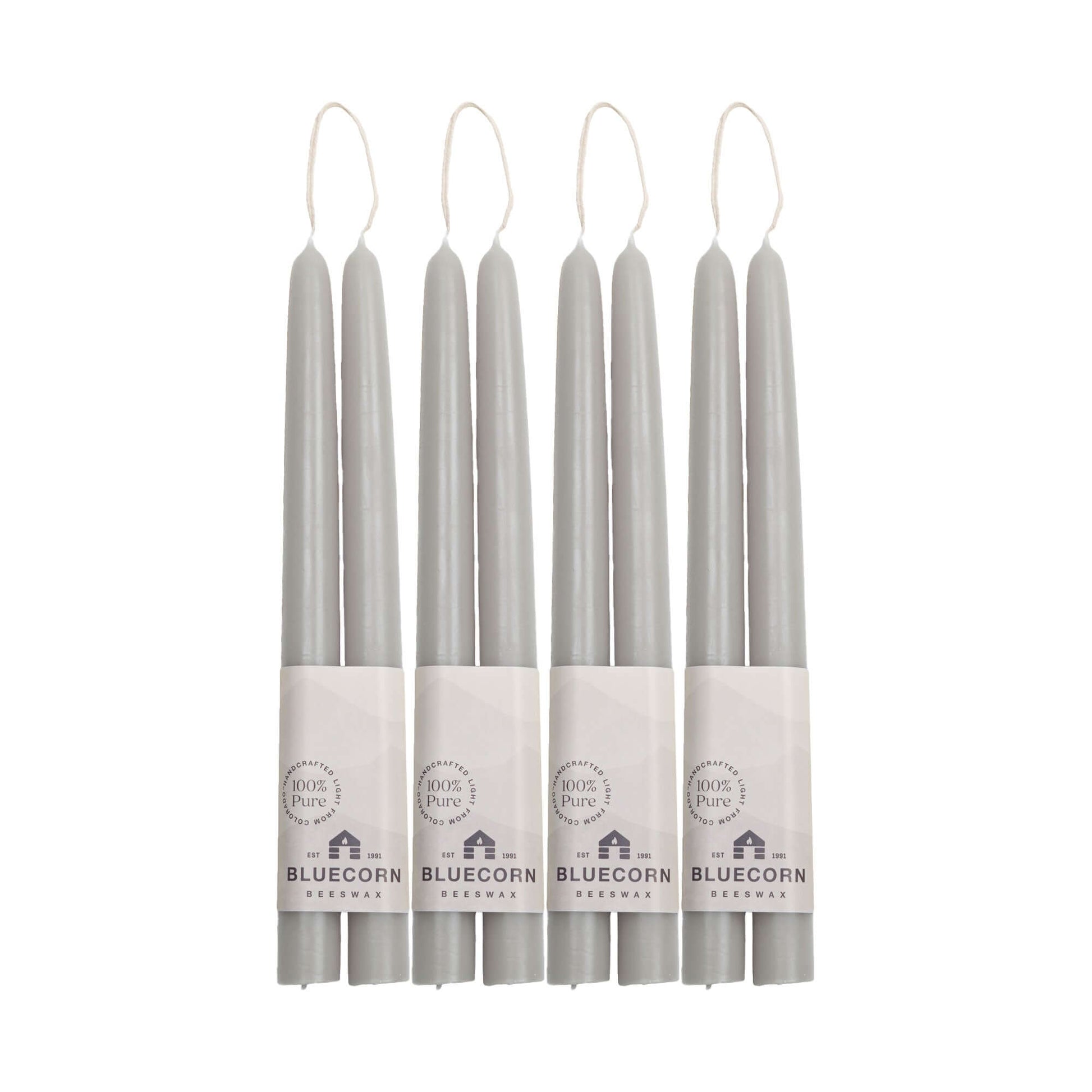 Set of eight gray candles with Bluecorn branding on a white background