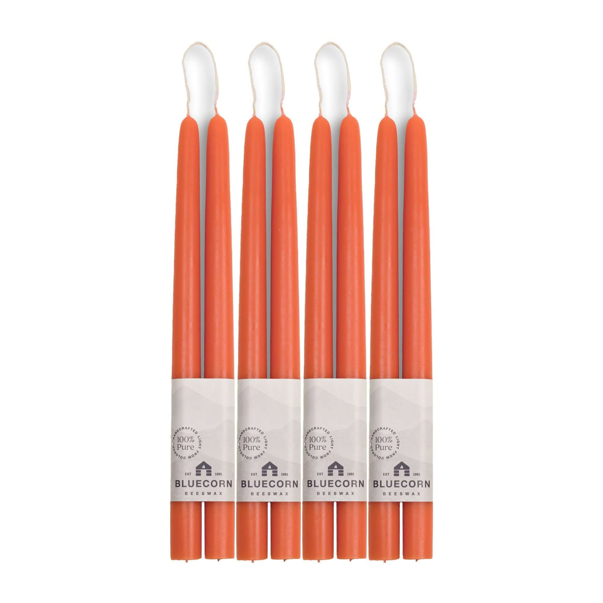 Set of apricot candles with white wicks on a white background