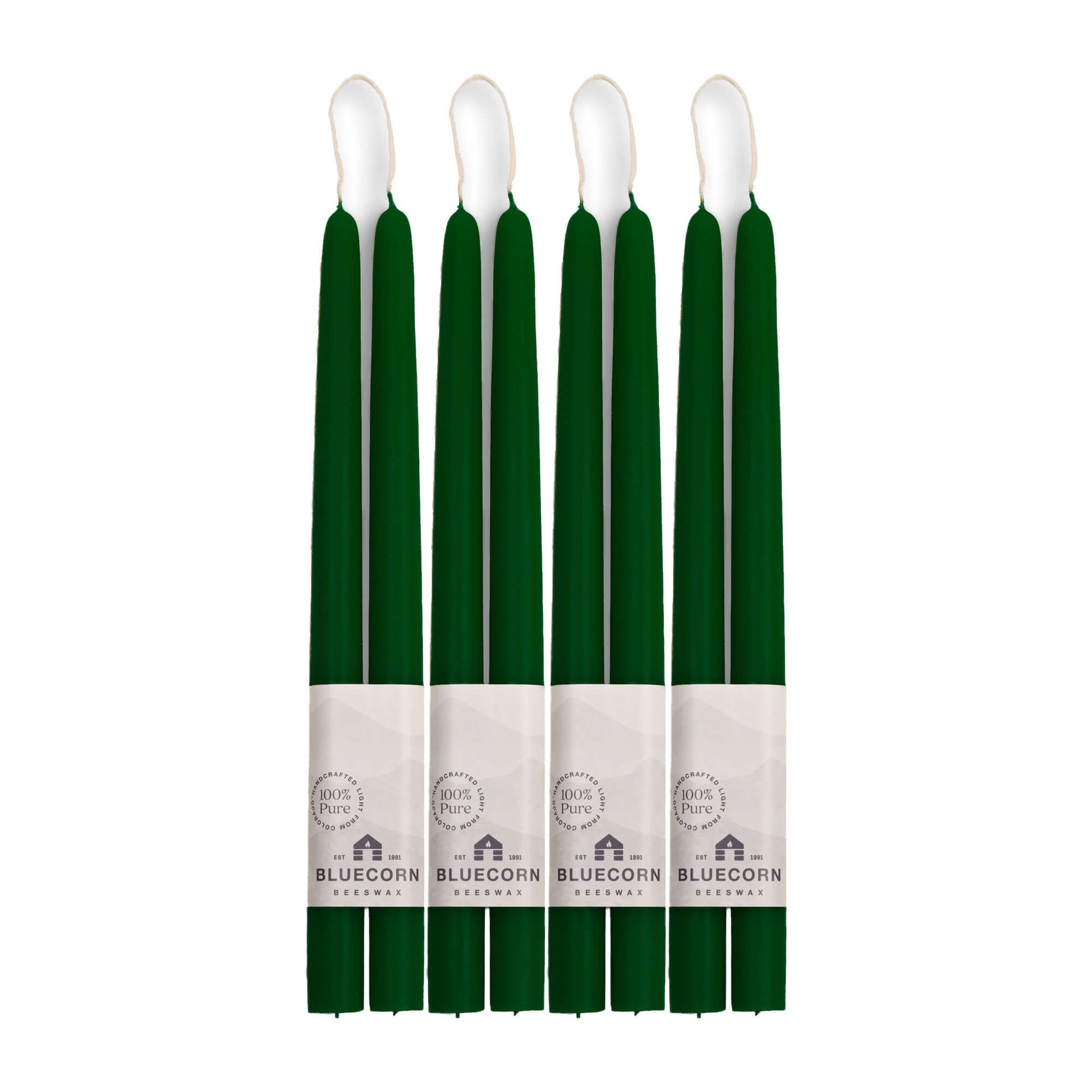 Set of eight green candles with white wicks on a white background