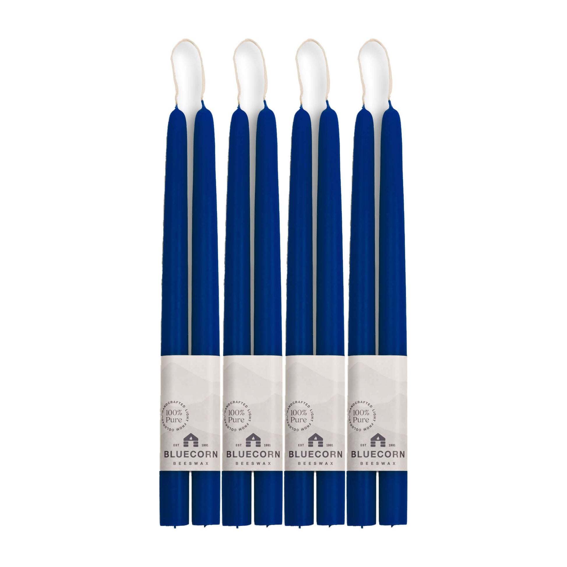 Set of eight blue candles with white wicks on a white background