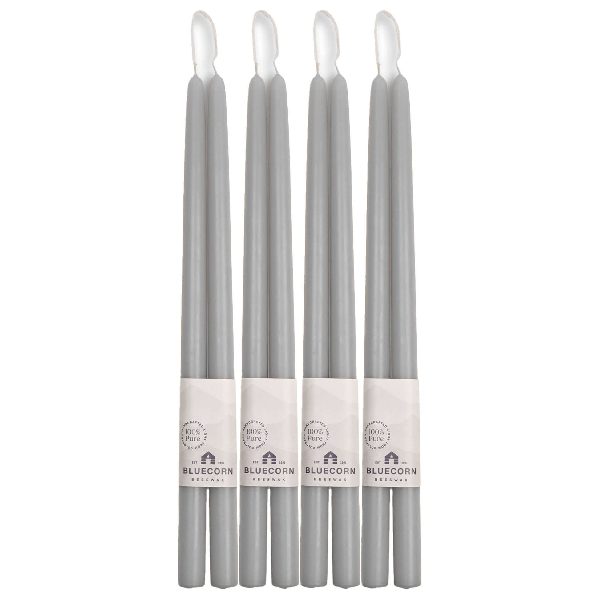 Set of gray candles with Bluecorn Festival labels on a white background