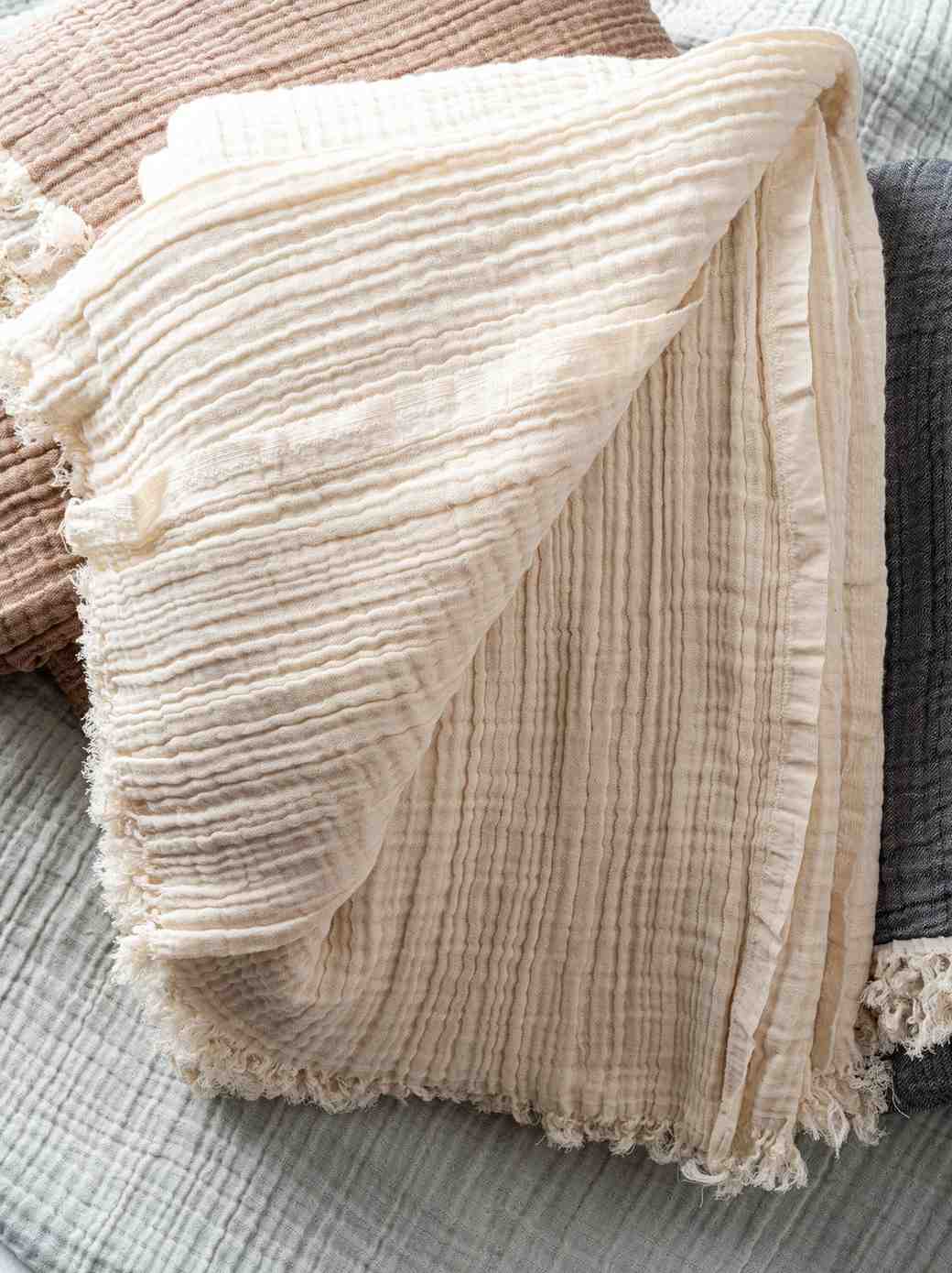 Beige Premium 100% cotton Turkish Muslin Cotton Blanket – 4-Layer Queen Size on a soft surface