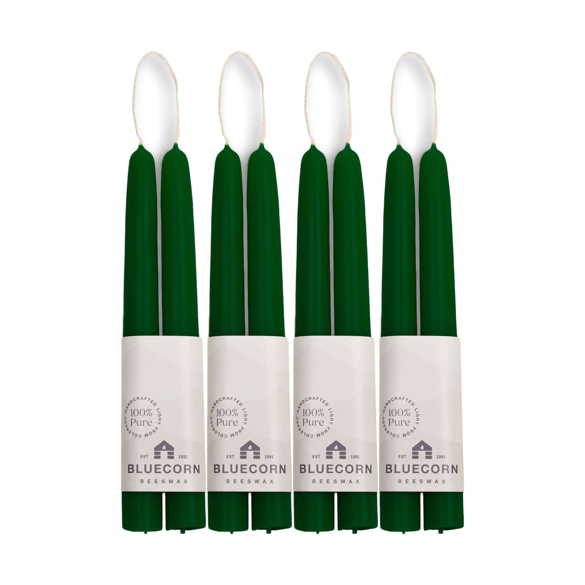 Eight green candles with white labels on a white background