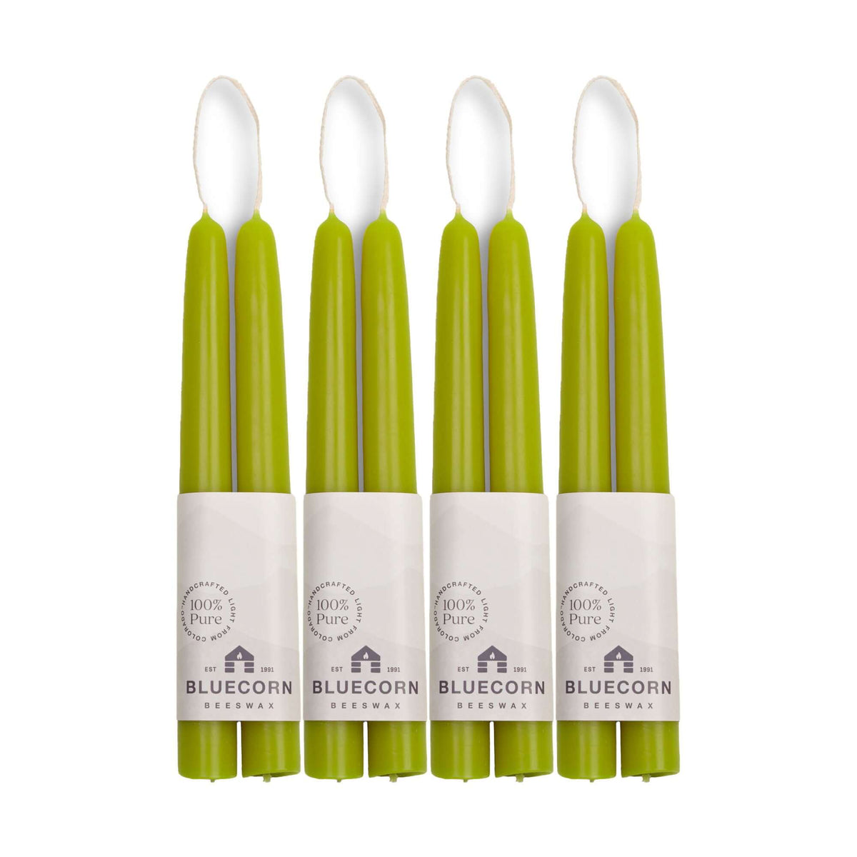 Set of eight green candles with white labels on a white background