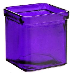 Purple glass tea light candle holder on a white background