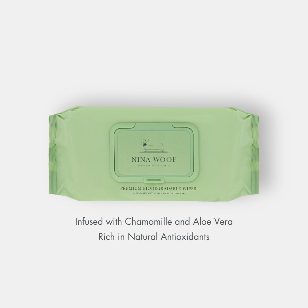 Green package of Nina Woof biodegradable pet wipes made with Chamomile and Aloe Vera, rich in antioxidents, on a white background