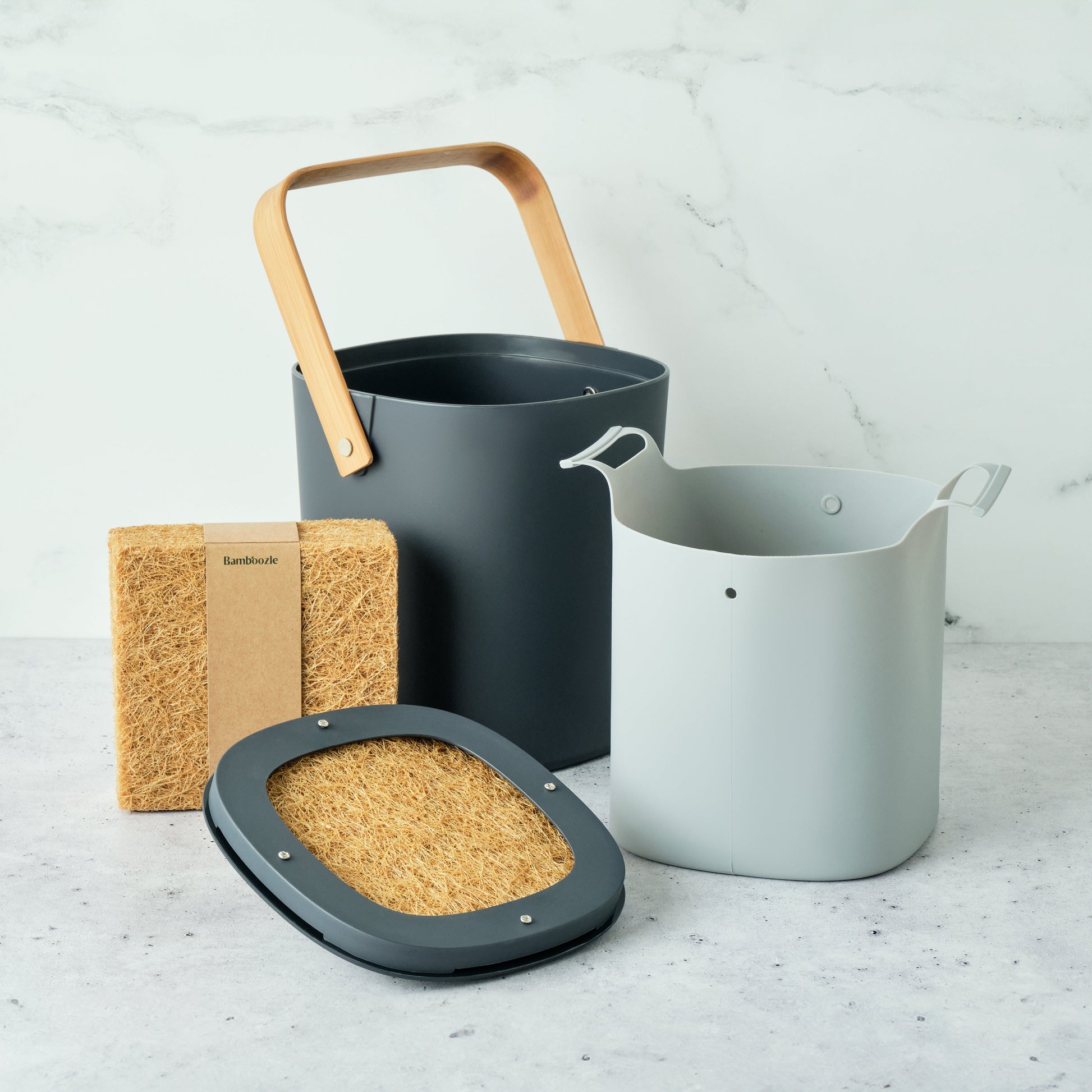 Astrik Compost Starter Bundle with a bamboo filter on a light gray surface