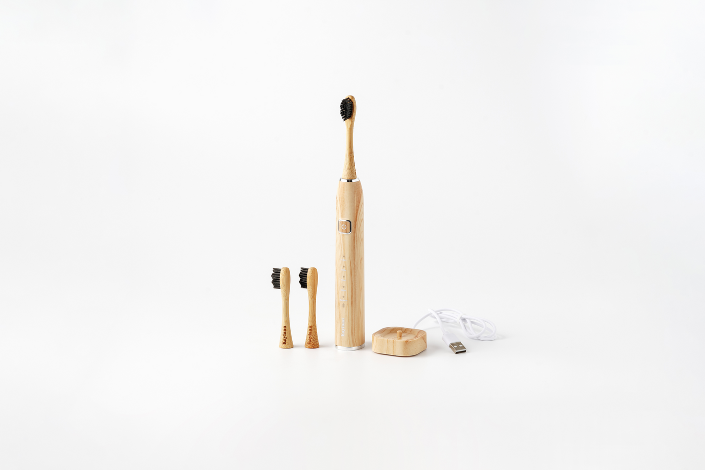 Kaylaan Bamboo Electric Toothbrush Set, shown with replacement bamboo heads and charging station on a white background