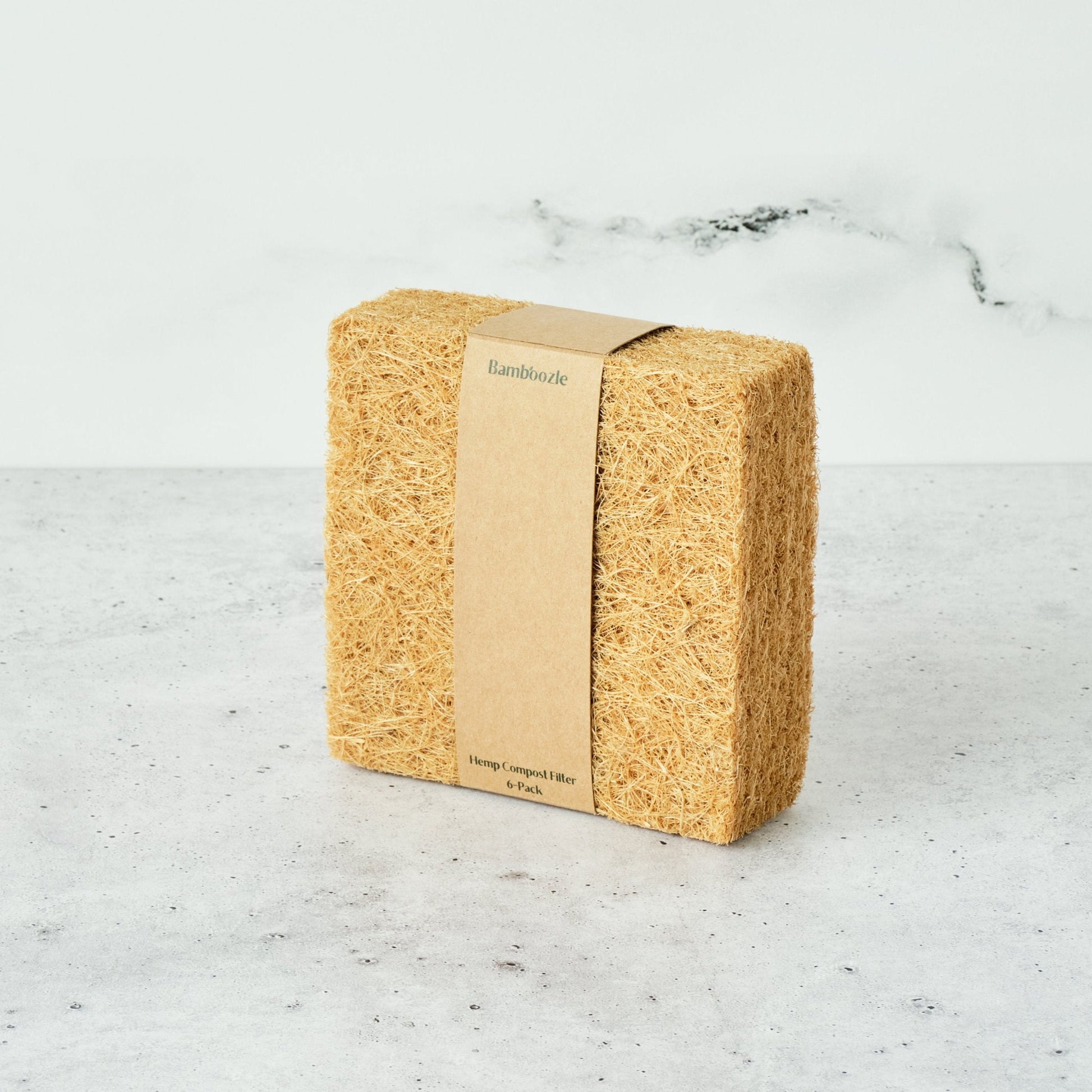 6-pack of biodegradable compost bin filters by Bamboozle, suited for the Astrik Indoor Compost Bin 1-year of odor control on a marble surface