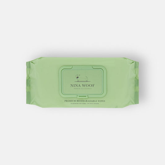 Green package of Nina Woof premium biodegradable pet wipes on a white background