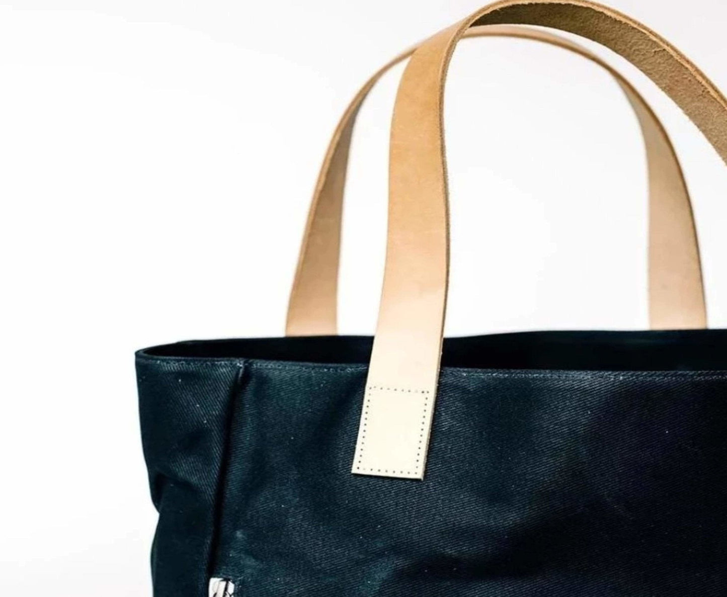 Black Waxed Canvas Tote Bag with Royal Blue Nylon Lining and beige straps – Durable & Stylish - on a white background