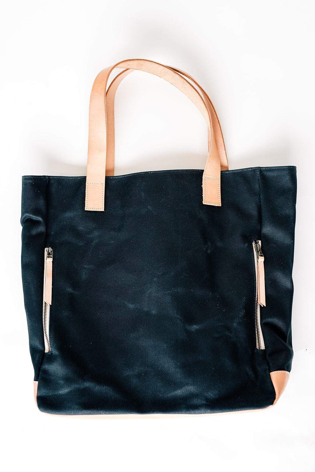 Black Waxed Canvas Tote Bag with Royal Blue Nylon Lining – Durable & Stylish - with beige handles and zippers on a white background